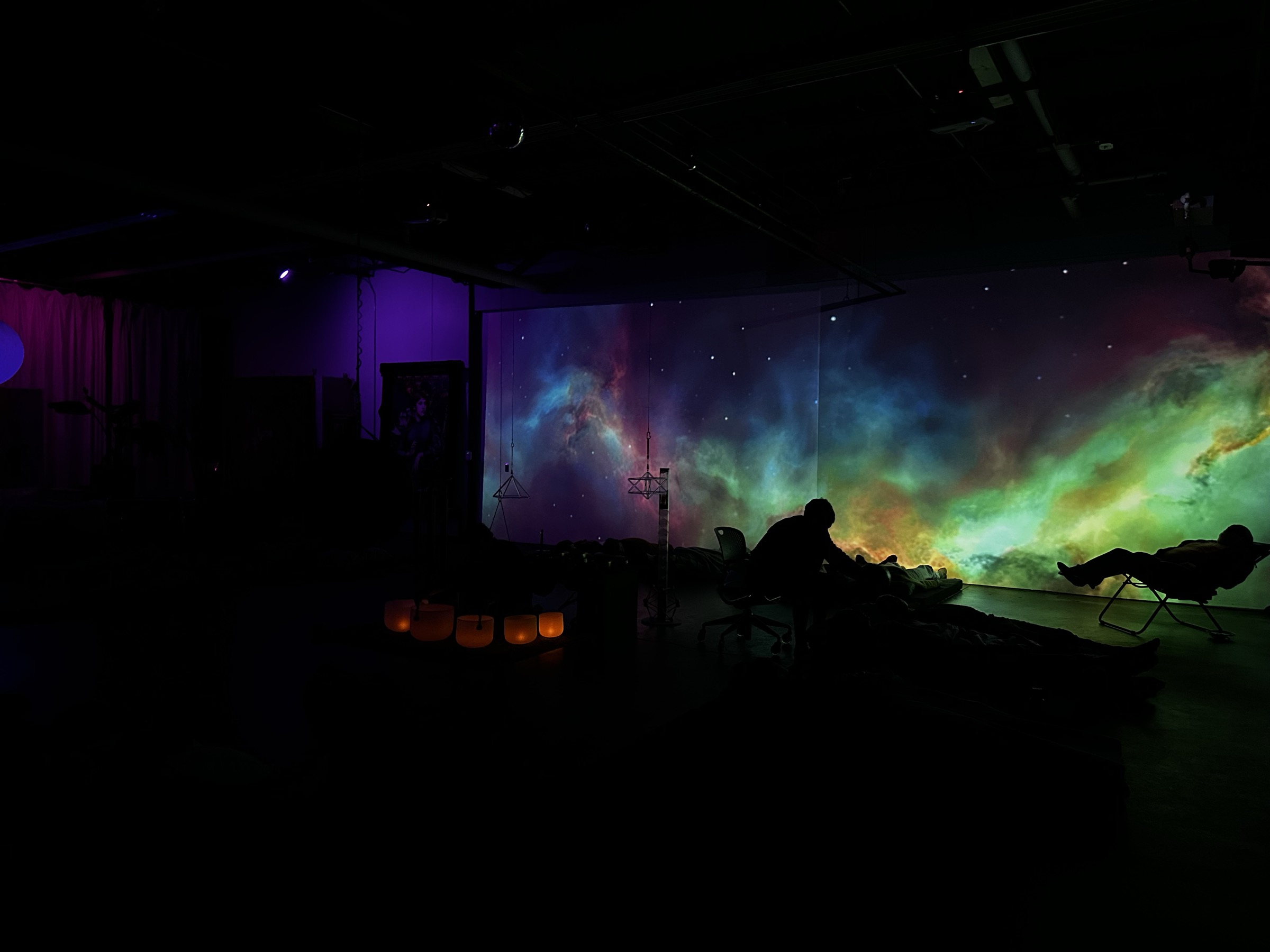 Guests recline beneath nebula projection