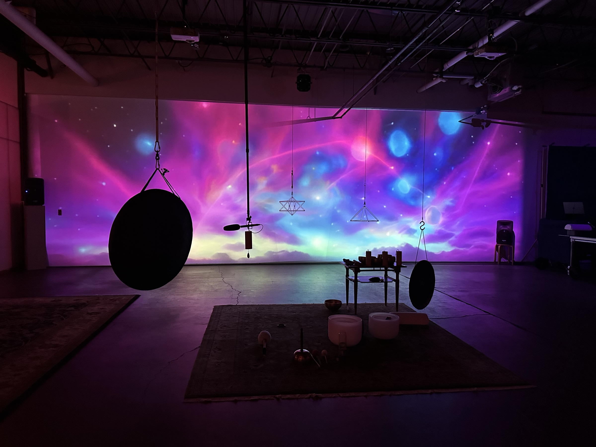 Cosmic nebula projection with singing bowls and gongs